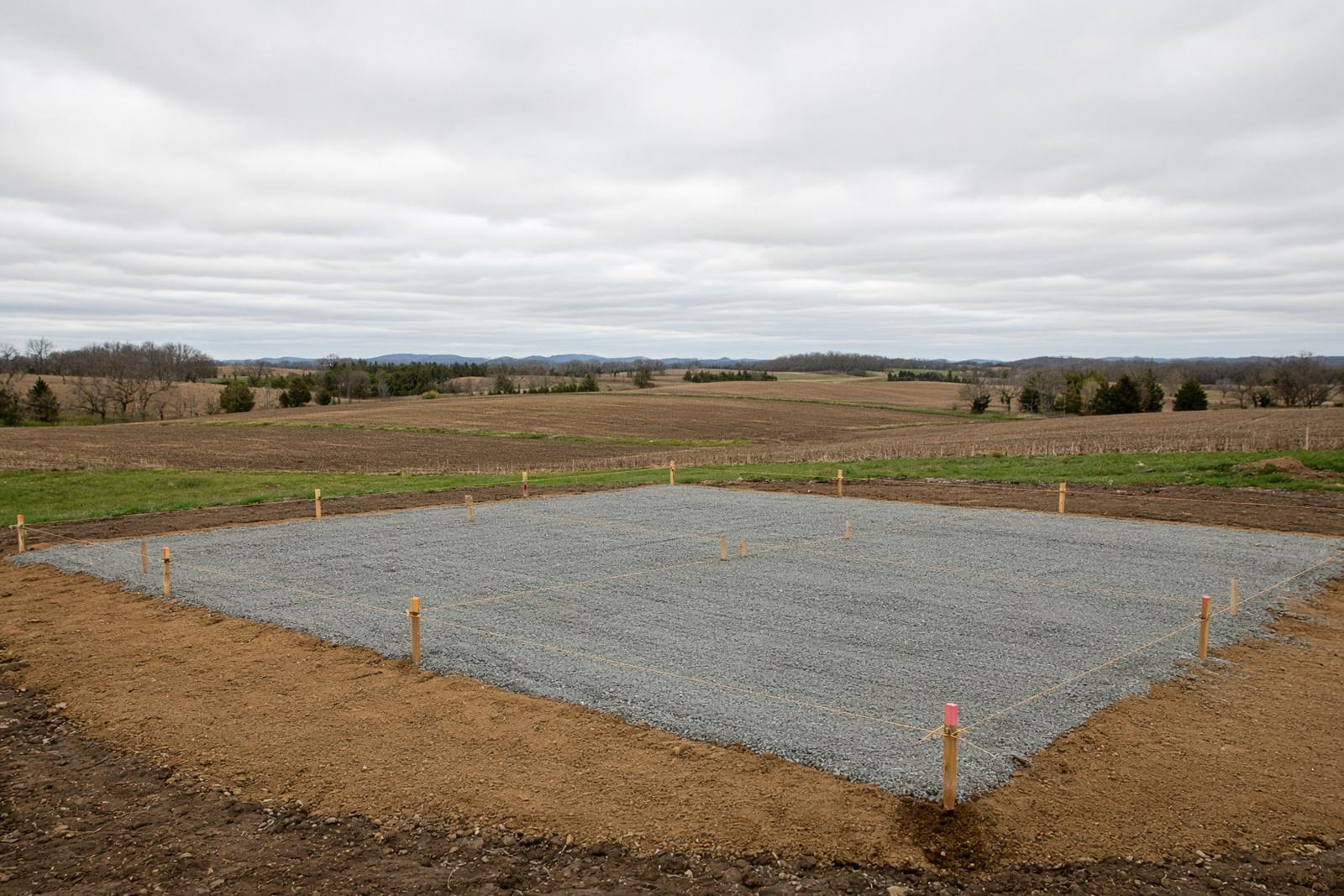 Staked building pad with a gravel base